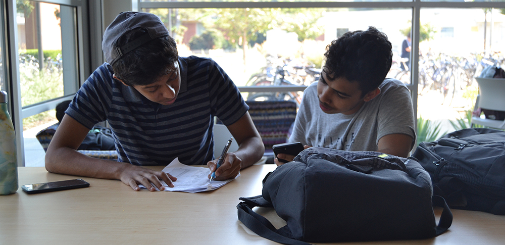 two male students studying at table