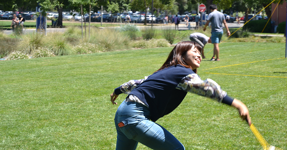 girl playing badminton outside