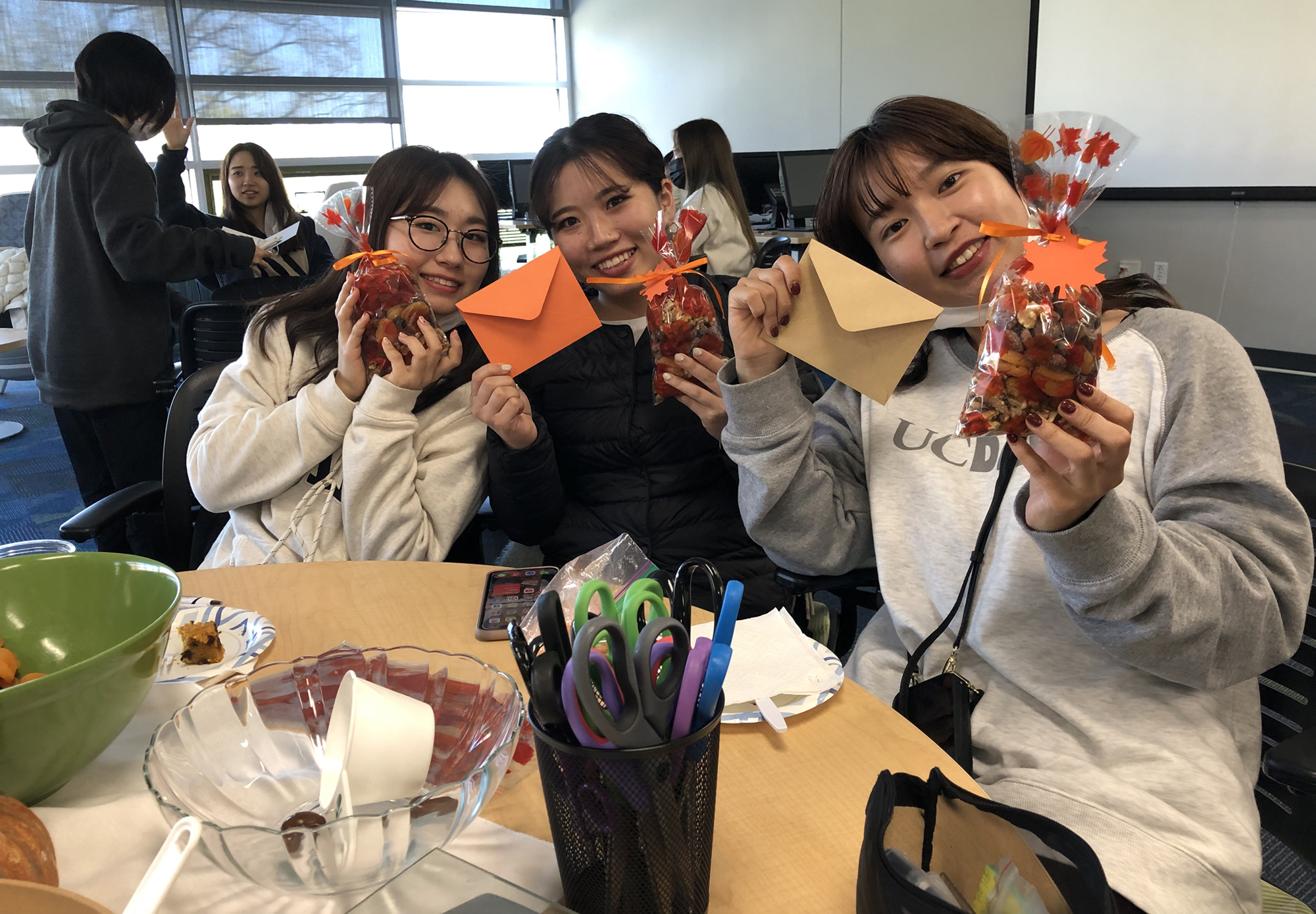 students smiling in classroom with crafts