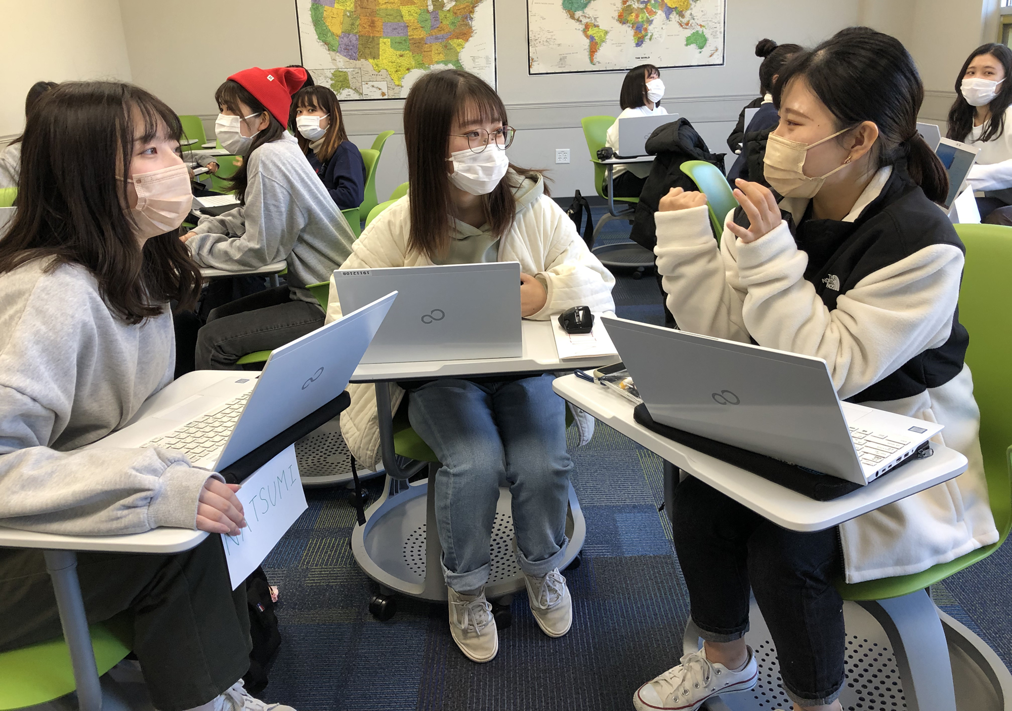 students with masks talking in class