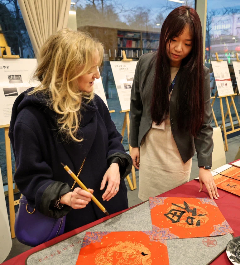 YiFie, a UC Davis GSP alumna, instructs someone on Chinese Ink painting