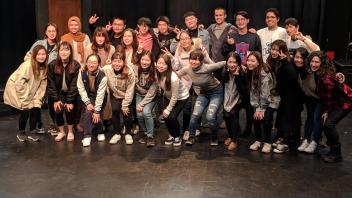 Group photo of students at a theatre