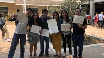 Students holding program certificates