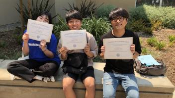 Students holding program certificates