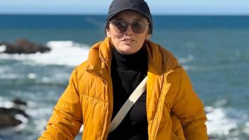UC Davis international student Banu poses in front of Monterey Bay