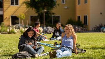 students hang out on the lawn outside the dorms
