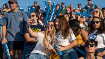 Students celebrate UC Davis Aggies during a homecoming football game