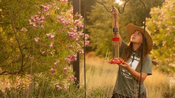 Student intern for the Arboretum Elizabeth Hursch put out the feeder in the hummingbird garden