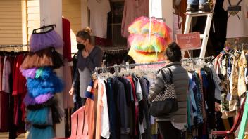 Students shop at the outdoor used clothing racks of Boheme