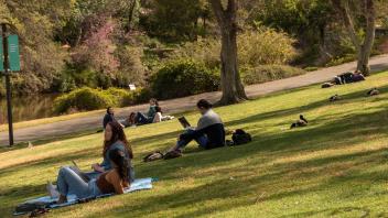 Students enjoy the spring weather on the lawn of the Arboretum