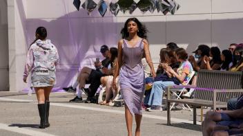 college female walks down runway during fashion show