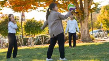 international students play volleyball outside the International Center