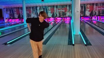 a student smiles after his turn at bowling at the Memorial Union