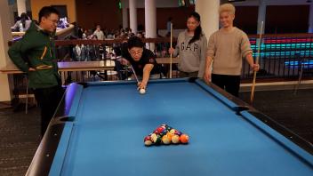 students play billiards at the memorial union on campus