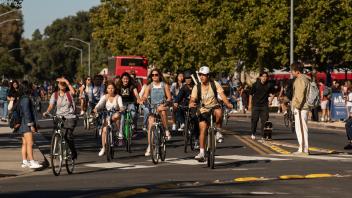 Students walk and ride by the Silo during the first day of class 