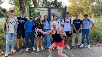 group of students and one smiling in the front at the UC Davis Arboretum