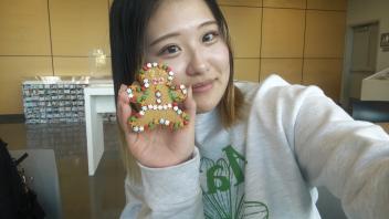 A student takes a selfie with a cookie she decorated 