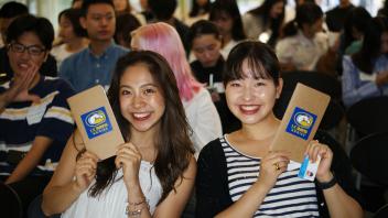 Two UC Davis GSP students pose with their UC Davis Aggie notebooks during orientation