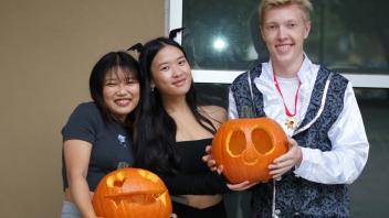 UC Davis International students show off their pumpkin carving skills at a Halloween party