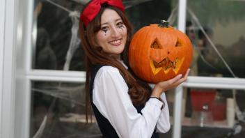 UC Davis International students show off their pumpkin carving skills at a Halloween party