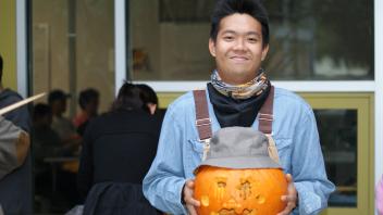 UC Davis International students show off their pumpkin carving skills at a Halloween party