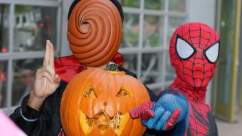 UC Davis International students show off their pumpkin carving skills at a Halloween party