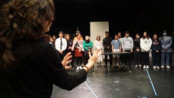 Instructor Leavy congratulates her students after their performances