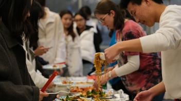 a group of students help themselves to the Chinese dinner buffet