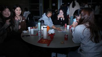 students play games at night during the Lunar New Year celebration