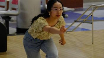 GREAT Program student focuses on her bowling game at the Memorial Union Game Area.