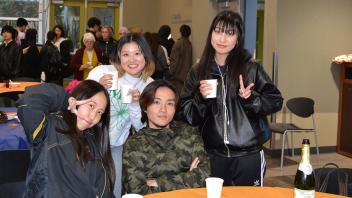 international students pose after enjoying their Thanksgiving meal