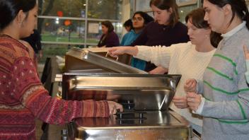 students grab food in the Thanksgiving buffet line