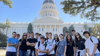 students pose in front of the State Capitol in Sacramento