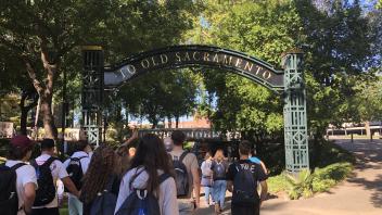 students walk toward the entrance to Old Town Sacramento