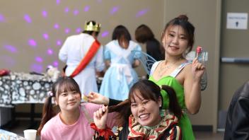 A group of UC Davis international students in costume pose during the annual Halloween Party.