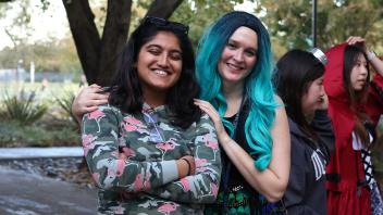 Two UC Davis international students in costume pose during the annual Halloween Party.