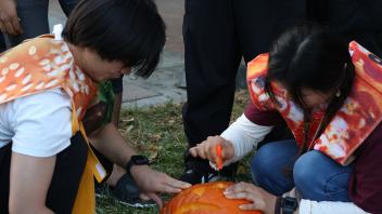 UC Davis international students carve pumpkins during the annual Halloween Party.