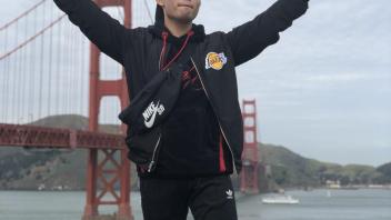 an international student poses in front of Golden Gate Bridge
