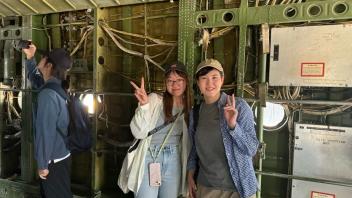 UC Davis international students pose in an airplane at the Aerospace Museum of California