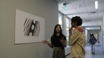 YiFei Li introduces a painting to her friend