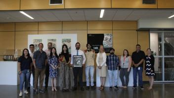 YiFei Li and International Programs staff pose in front of her exhibition