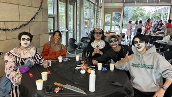 A group of UC Davis international students in costume pose during the annual Halloween Party.