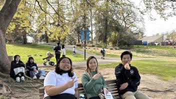 Seikei High School students take a break on a bench at the Arboretum