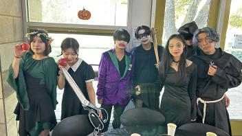 A group of UC Davis international students in costume pose during the annual Halloween Party.