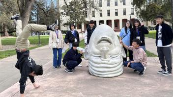 Seikei High School students pose next to the Eye on Mrak egghead