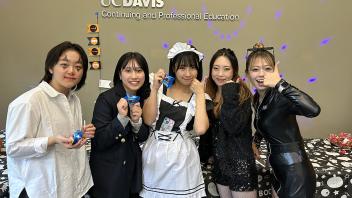 A group of UC Davis international students in costume pose during the annual Halloween Party.