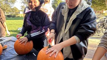 UC Davis international students carve pumpkins during the annual Halloween Party.