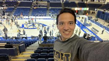 International business student at UC Davis Carlos Maya Ortega takes a selfie at a UC Davis basketball game