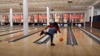 a student bowls in the games area of the Memorial Union