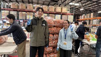 Seikei High School students pose with carrots at the Sacramento Food Bank